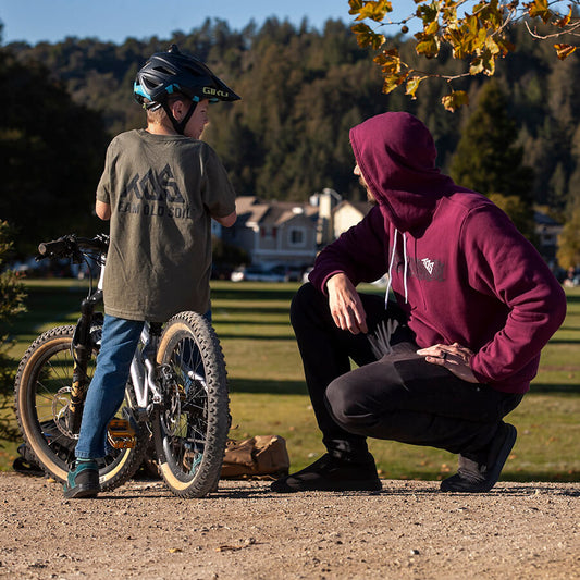 male wearing maroon pullover hooded sweatshirt