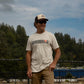 Male wearing Traction tee and Classic Brown Tan Brown trucker hat with TOS logo.