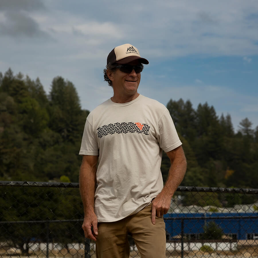 Male wearing Traction tee and Classic Brown Tan Brown trucker hat with TOS logo.
